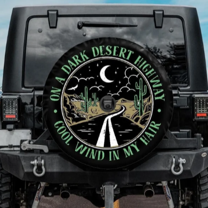 on a dark desert highway jeep tire cover